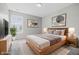 Staged bedroom boasts neutral decor, natural wood furniture, and ample natural light at 9949 Nightsong Ln, Avon, IN 46123