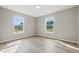 Light-filled bedroom with sleek flooring and two bright windows at 9949 Nightsong Ln, Avon, IN 46123