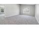 This bright bedroom features a neutral color palette, carpet, and a window at 9949 Nightsong Ln, Avon, IN 46123