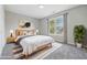 Staged bedroom features decor that enhances the natural light and views at 9949 Nightsong Ln, Avon, IN 46123