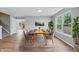 Dining room features wood-look floors, natural light, and staircase to upper level at 9949 Nightsong Ln, Avon, IN 46123