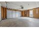 Spacious, unfinished garage featuring a large gray garage door and access door at 9949 Nightsong Ln, Avon, IN 46123