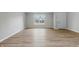 Open-plan living room with wood-look flooring and a large window allowing ample natural light at 9949 Nightsong Ln, Avon, IN 46123
