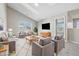 Staged living room with vaulted ceilings, neutral walls, a large window, and furniture at 9949 Nightsong Ln, Avon, IN 46123