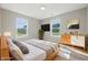 Staged primary bedroom with neutral walls, two windows, carpet, and furniture at 9949 Nightsong Ln, Avon, IN 46123