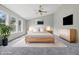 Bright main bedroom featuring a ceiling fan, hardwood furniture, and large sun-filled windows at 9949 Nightsong Ln, Avon, IN 46123