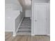 Carpeted stairway with white bannister and a closed door at 9949 Nightsong Ln, Avon, IN 46123