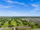 Aerial view showcases a sprawling neighborhood, close to a golf course, with many homes and green spaces at 10118 Falls Canyon Ln, Indianapolis, IN 46229