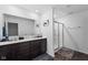 Bathroom featuring a double sink vanity with dark wood cabinets and a separate glass-enclosed shower at 10118 Falls Canyon Ln, Indianapolis, IN 46229