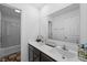 This bathroom features a dark vanity with a white countertop, a large mirror, and a shower/tub combo at 10118 Falls Canyon Ln, Indianapolis, IN 46229