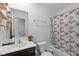 This bathroom features a single sink vanity and shower/tub combo with stylish leaf-patterned shower curtain at 10118 Falls Canyon Ln, Indianapolis, IN 46229