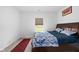 This bedroom offers a beautiful wooden bed frame and a sunny window with views of the outdoors at 10118 Falls Canyon Ln, Indianapolis, IN 46229