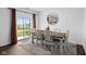 Bright dining room with a wooden table, stylish chairs, and a sliding glass door to the backyard at 10118 Falls Canyon Ln, Indianapolis, IN 46229