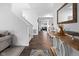 Bright entryway featuring hardwood floors, a staircase, and a decorative console table at 10118 Falls Canyon Ln, Indianapolis, IN 46229