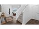 Entryway with staircase, hardwood floors, and a view into the living room, with a stairway to the second floor at 10118 Falls Canyon Ln, Indianapolis, IN 46229