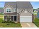 Charming two-story home featuring a well-manicured lawn and an attached two-car garage at 10118 Falls Canyon Ln, Indianapolis, IN 46229