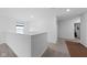 This hallway boasts neutral carpet and a freshly painted white railing for a clean, modern aesthetic at 10118 Falls Canyon Ln, Indianapolis, IN 46229
