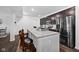 Modern kitchen featuring a large island with seating, stainless steel appliances, and dark cabinetry at 10118 Falls Canyon Ln, Indianapolis, IN 46229