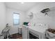 This laundry room includes modern appliances and convenient shelving for storage and organization at 10118 Falls Canyon Ln, Indianapolis, IN 46229