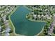 Aerial view of a community lake surrounded by homes with lush green landscape, creating a peaceful setting at 10262 Carmine Dr, Noblesville, IN 46060