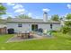 Backyard features a concrete patio, outdoor seating, grill, fenced yard, and verdant grass at 10262 Carmine Dr, Noblesville, IN 46060