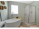 Modern bathroom showcases a standalone tub, glass-enclosed shower, and stylish fixtures creating a spa-like atmosphere at 10262 Carmine Dr, Noblesville, IN 46060