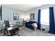 Cozy bedroom with a soft blue color scheme, featuring a comfortable seating area and well-lit desk at 10262 Carmine Dr, Noblesville, IN 46060