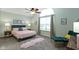A bright bedroom features a large window, a plush bed, and calming decor creating a serene and inviting retreat at 10262 Carmine Dr, Noblesville, IN 46060