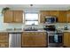 A well-lit kitchen with wooden cabinets, stainless steel appliances, and neutral countertops offers a functional cooking space at 10262 Carmine Dr, Noblesville, IN 46060