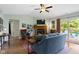 Cozy living room with fireplace, ceiling fan, and sliding glass doors to outside at 10262 Carmine Dr, Noblesville, IN 46060