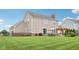 Spacious backyard with a patio, pergola, and ample lawn space, offering a perfect setting for outdoor activities at 10806 Solis Cir, Fishers, IN 46038
