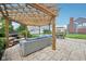 Inviting backyard patio features a pergola, outdoor seating, a built-in fire pit, and a cozy ambiance at 10806 Solis Cir, Fishers, IN 46038