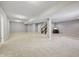 Large finished basement with plenty of open space, carpeting, and neutral walls, ready for customization at 10806 Solis Cir, Fishers, IN 46038