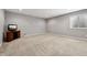 Carpeted basement rec room area with television, window, and comfortable layout for various activities at 10806 Solis Cir, Fishers, IN 46038