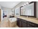 A bathroom with dual vanities, a soaking tub and a step in shower at 10806 Solis Cir, Fishers, IN 46038