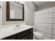 Cozy bathroom featuring a single vanity, framed mirror, and a tub with a shower with curtain at 10806 Solis Cir, Fishers, IN 46038