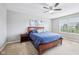 Cozy bedroom with a large bed, wooden furniture, neutral-colored walls, and a ceiling fan at 10806 Solis Cir, Fishers, IN 46038