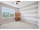 Bright bedroom with a desk, ample sunlight streaming through the window, and a charming accent wall at 10806 Solis Cir, Fishers, IN 46038