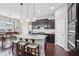 Stylish kitchen island with granite countertops, stainless steel sink, modern lighting, and seating for three at 10806 Solis Cir, Fishers, IN 46038