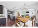 Open concept kitchen with stainless steel appliances, granite countertops, and access to the dining and living areas at 10806 Solis Cir, Fishers, IN 46038