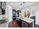 Modern kitchen with stainless steel appliances, granite countertops, dark wood cabinets and a large island at 10806 Solis Cir, Fishers, IN 46038