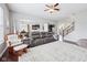 Open-concept living room showcasing the kitchen and dining area with dark hardwood floors and a large rug at 10806 Solis Cir, Fishers, IN 46038