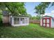 Backyard featuring a sunroom addition, shed and partial view of the house at 1106 N Sheffield Ave, Indianapolis, IN 46222