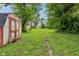 Lush backyard featuring a storage shed and a clear view down the lot at 1106 N Sheffield Ave, Indianapolis, IN 46222