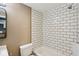 Bathroom featuring white tiled shower and neutral walls at 1106 N Sheffield Ave, Indianapolis, IN 46222