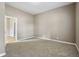 Neutral bedroom showcasing carpet, paint, and view to another room at 1106 N Sheffield Ave, Indianapolis, IN 46222