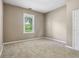 Cozy bedroom with neutral carpet, paint, and view of backyard through window at 1106 N Sheffield Ave, Indianapolis, IN 46222