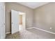 Bedroom showcasing carpet, neutral paint, windows and entry to another room at 1106 N Sheffield Ave, Indianapolis, IN 46222