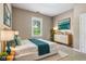 Serene bedroom featuring a queen bed, modern dresser, and green accents, creating a restful retreat at 1106 N Sheffield Ave, Indianapolis, IN 46222