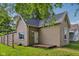 Charming single-story home with tan siding and a well-manicured lawn, showcasing curb appeal at 1106 N Sheffield Ave, Indianapolis, IN 46222